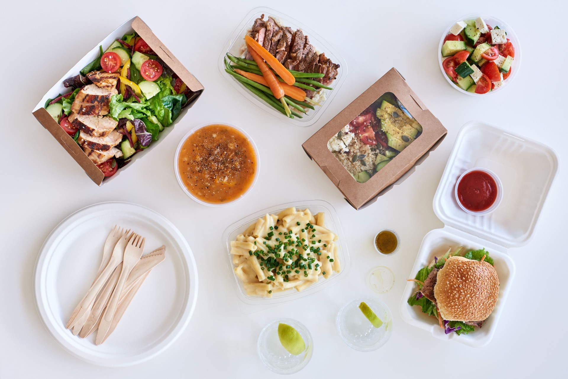 Overhead view of gourmet takeaway food on a white background